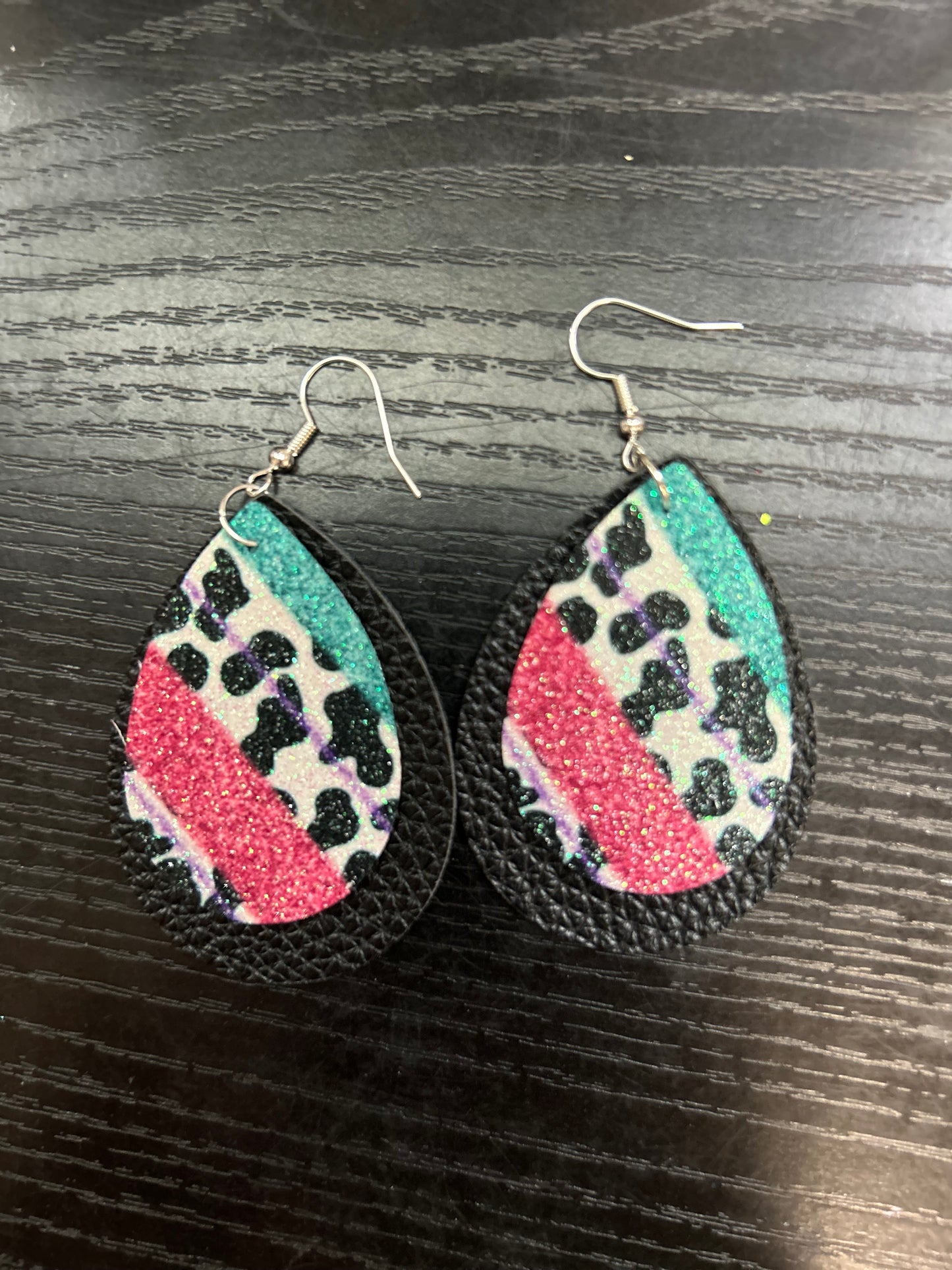 Cow print with pink/teal on black